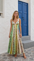 Front view of woman wearing multi-color floral panel maxi dress