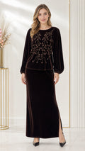 Front full-length view of woman wearing a dark brown beaded velvet two-piece maxi skirt set