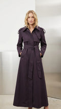 Front view of model wearing full-length deep purple belted maxi trench coat