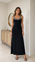 Full front view of model wearing black sleeveless rhinestone trim scoop neck maxi dress